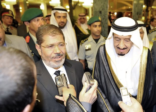 Egyptian President Mohamed Morsi (CL) speaks to reporters alongside Saudi Crown Prince Salman bin Abdulaziz (CR) upon arrival in Jeddah on July 11, 2012. Morsi is on his first foreign trip since taking office. AFP/STR / AFP PHOTO / -